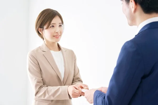 名刺交換する二人のビジネスパーソン